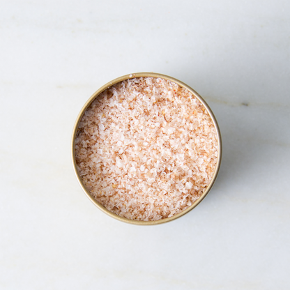 a container of salt on a marble surface