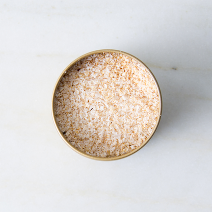 a container of salt on a marble surface