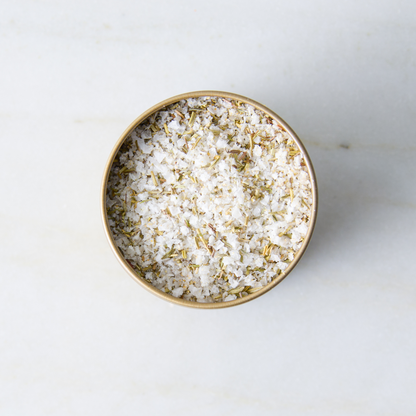 a container of salt on a marble surface