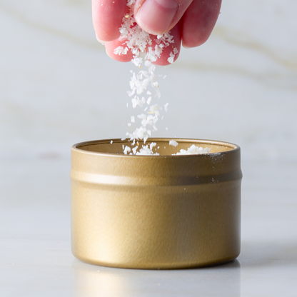 a hand pouring salt into a container