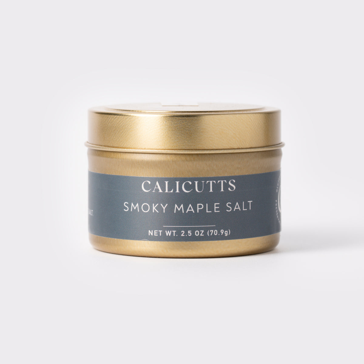 a small gold container with a blue label